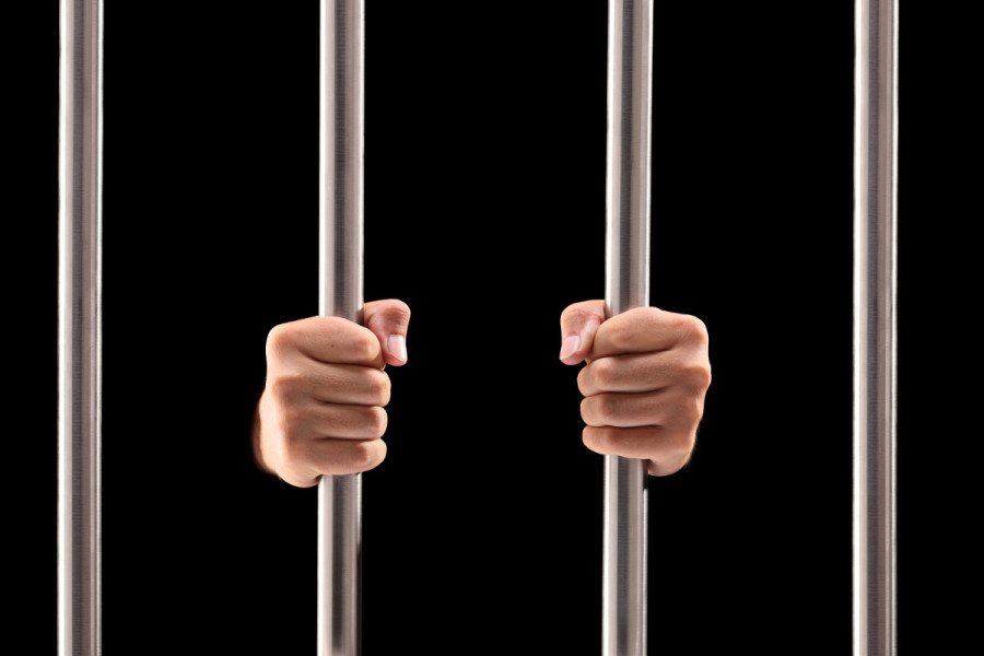 holding prison bars black background